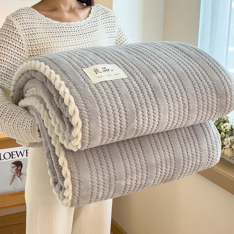 Solid colour jacquard milk velvet blanket in cream white on a bed with Nordic-style decor