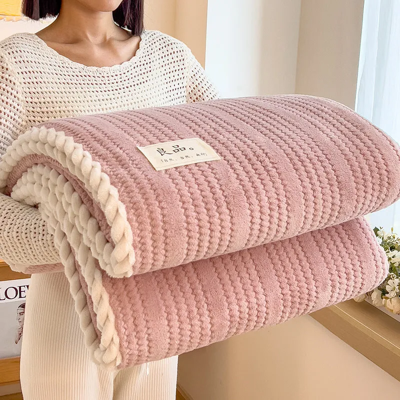 Solid colour jacquard milk velvet blanket in cream white on a bed with Nordic-style decor