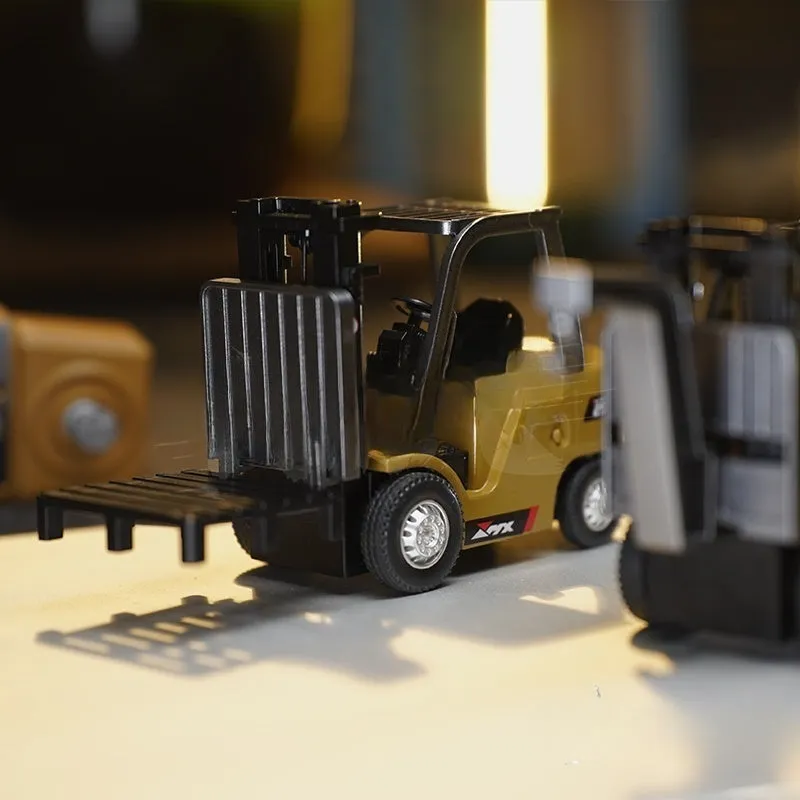 Alloy remote control engineering vehicle set with dump truck, excavator, and small forklift on a table