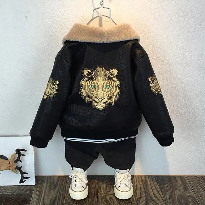 Black PU leather long-sleeved plus velvet jacket for boys with lapel collar and zipper closure, flat lay view