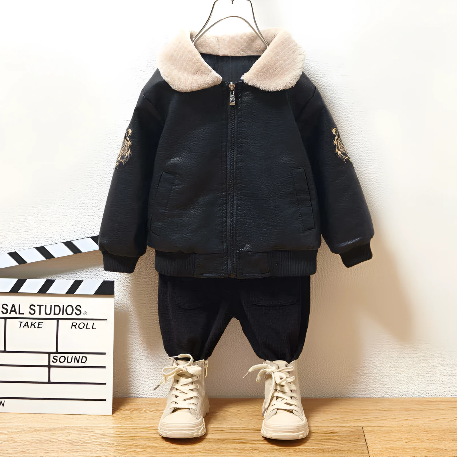 Black PU leather long-sleeved plus velvet jacket for boys with lapel collar and zipper closure, flat lay view