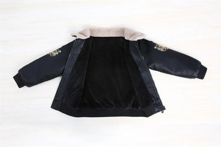 Black PU leather long-sleeved plus velvet jacket for boys with lapel collar and zipper closure, flat lay view