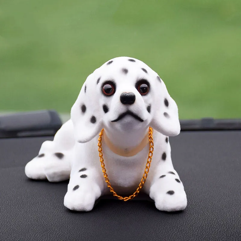 Synthetic resin shake head dog doll in husky design with white auspicious fruit accent on car dashboard