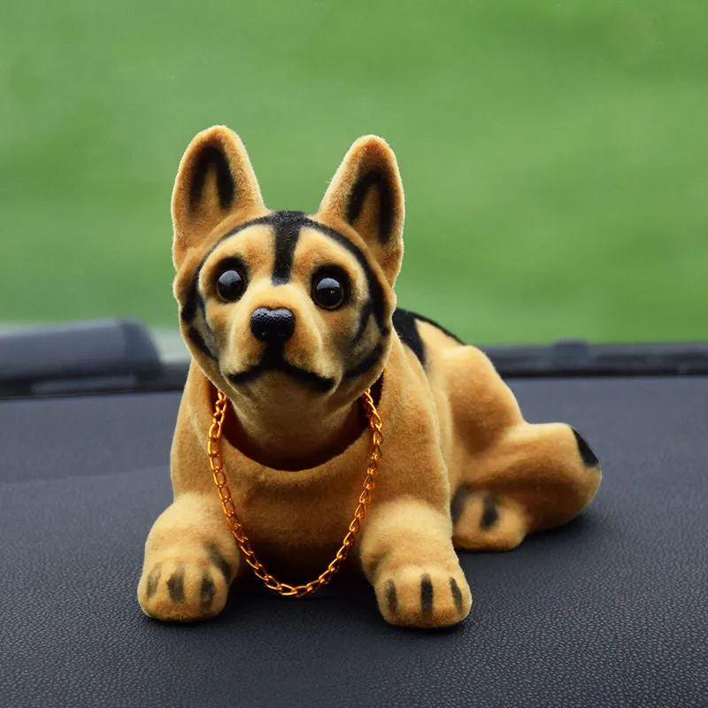 Synthetic resin shake head dog doll in husky design with white auspicious fruit accent on car dashboard