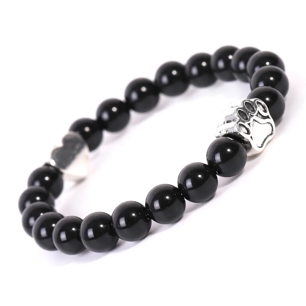 Tigereye and Indian agate stone beaded bracelet with a silver dog's paw charm and a geometric peach heart charm on a white background.