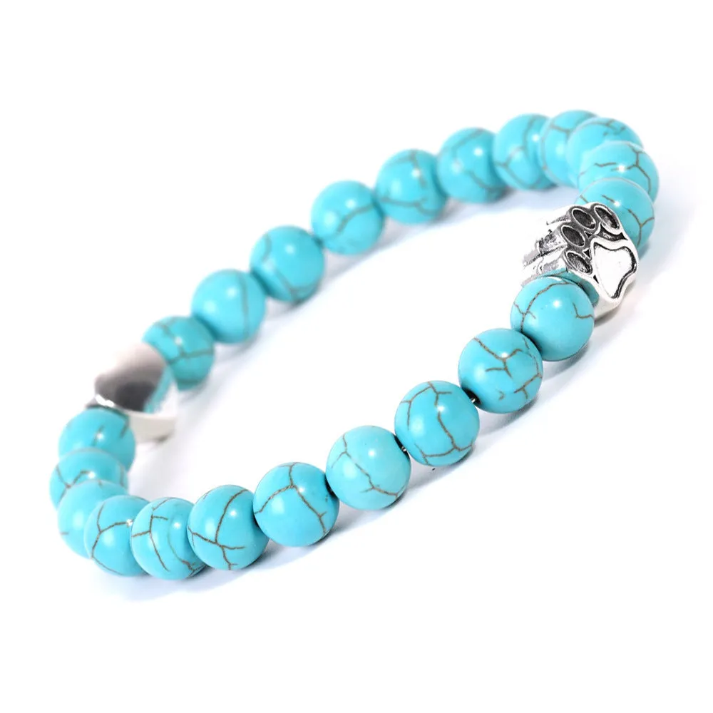 Tigereye and Indian agate stone beaded bracelet with a silver dog's paw charm and a geometric peach heart charm on a white background.