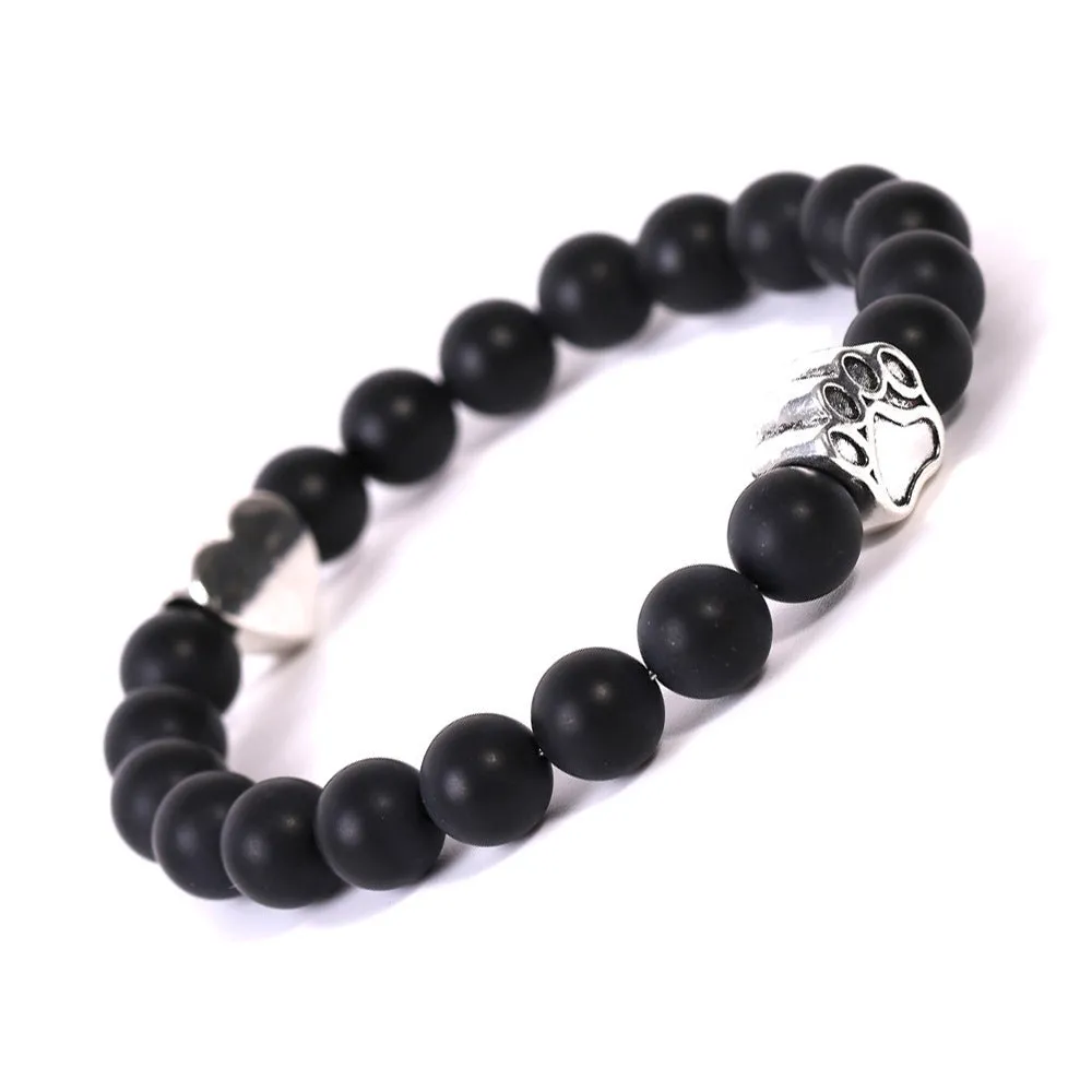 Tigereye and Indian agate stone beaded bracelet with a silver dog's paw charm and a geometric peach heart charm on a white background.