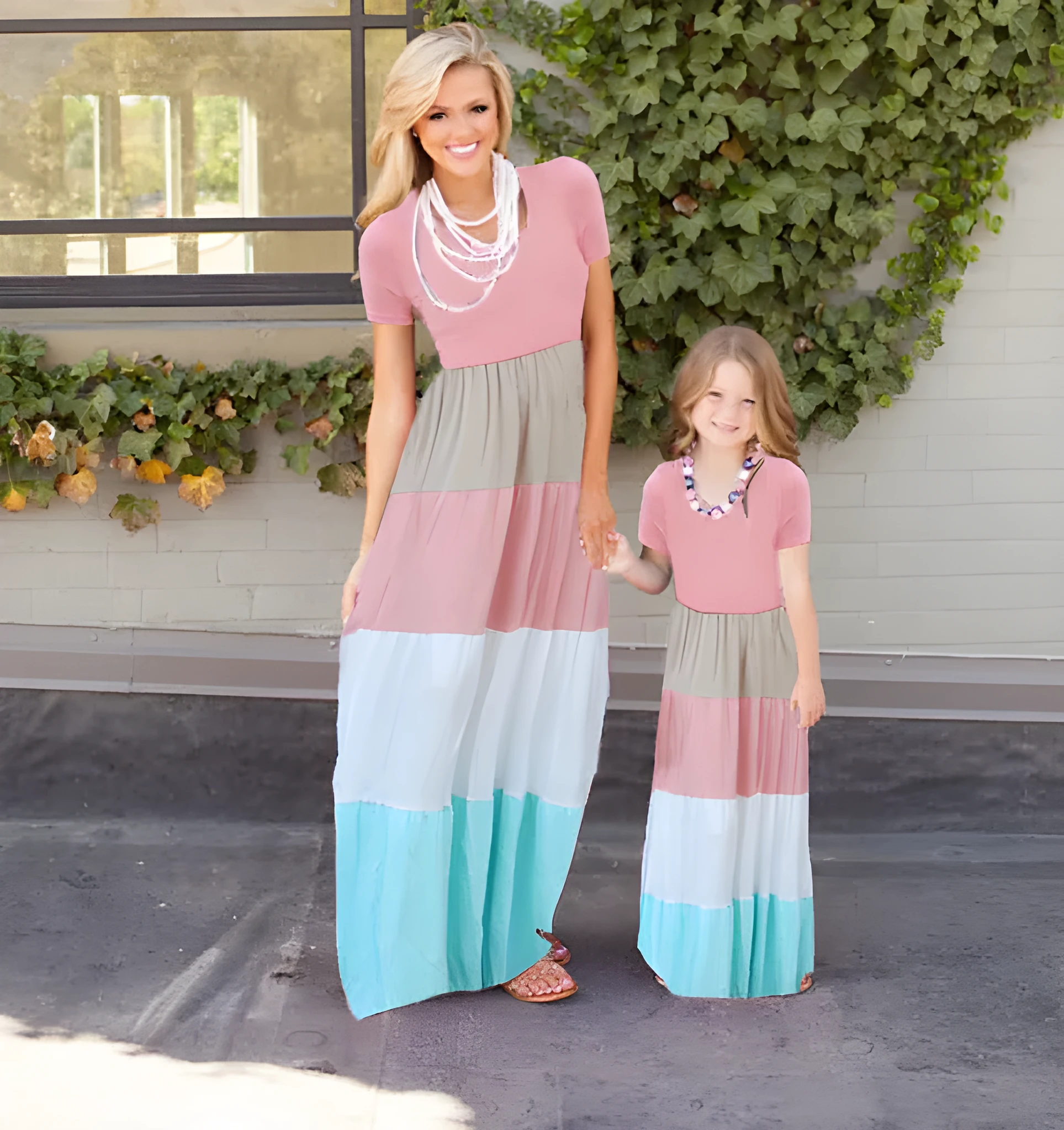 Short-sleeved pink parent-child dress with large swing skirt and round neck on a woman and child