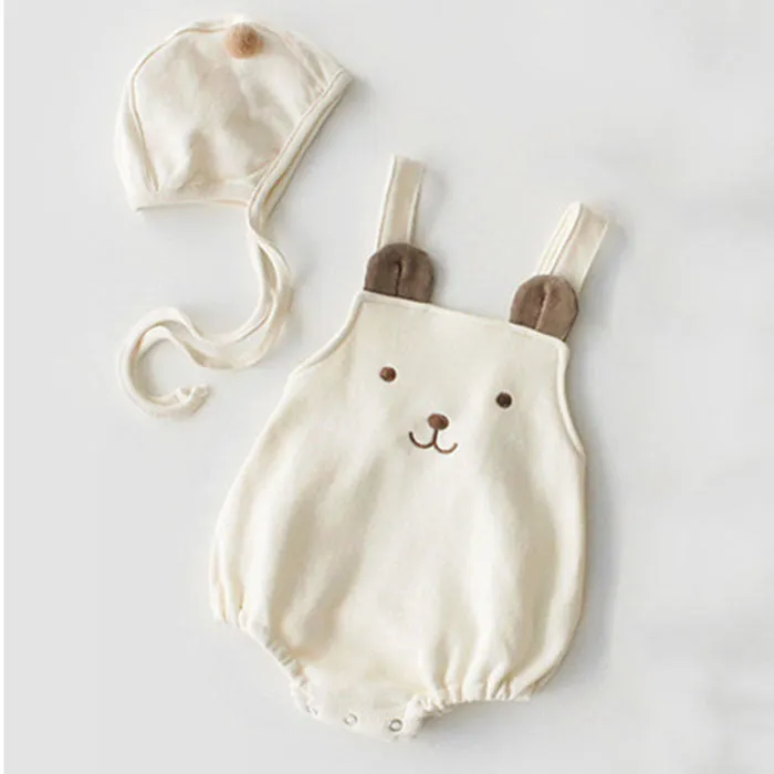 Baby sleeveless strapless cotton robe with detachable hood in brown or white on a plain background