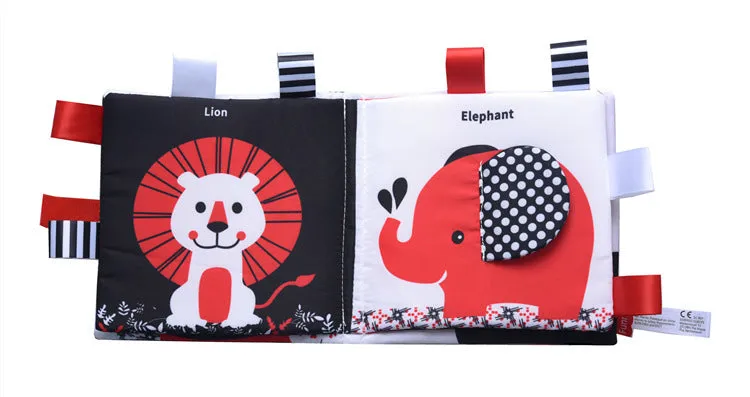 Four cloth books with bird, snail, zebra, and ABC designs featuring haha mirror and rattle functions
