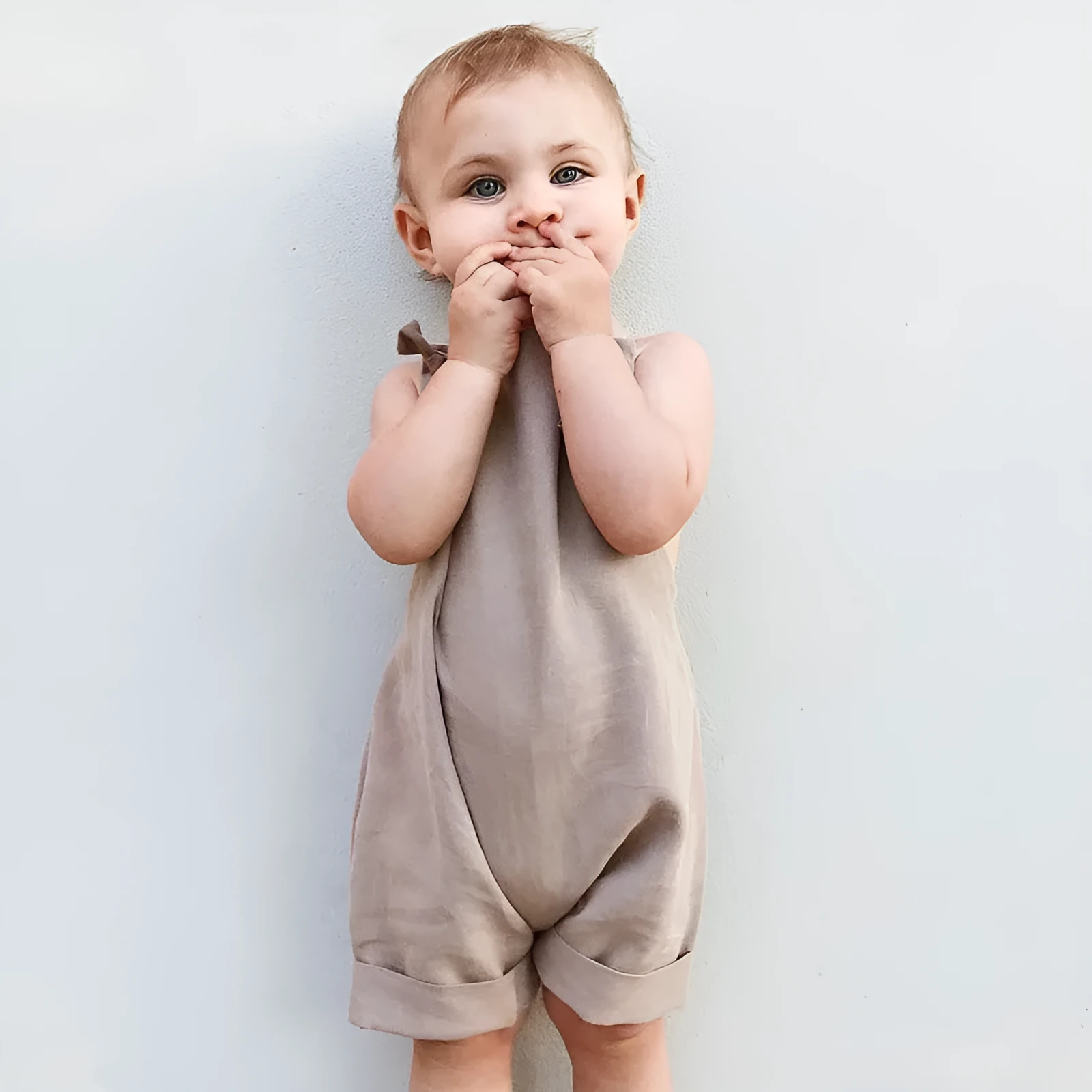 Children's khaki cotton overalls shorts with bow detail and straps, front view