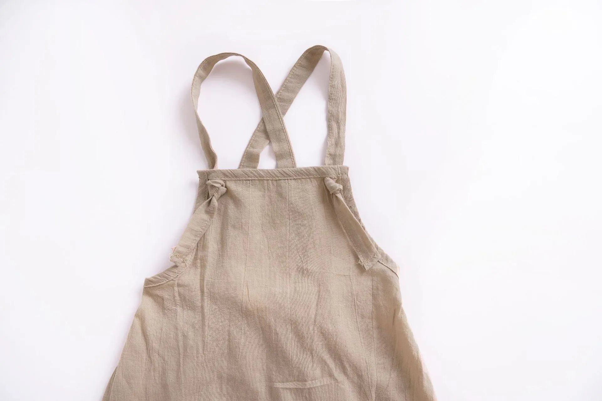 Children's khaki cotton overalls shorts with bow detail and straps, front view