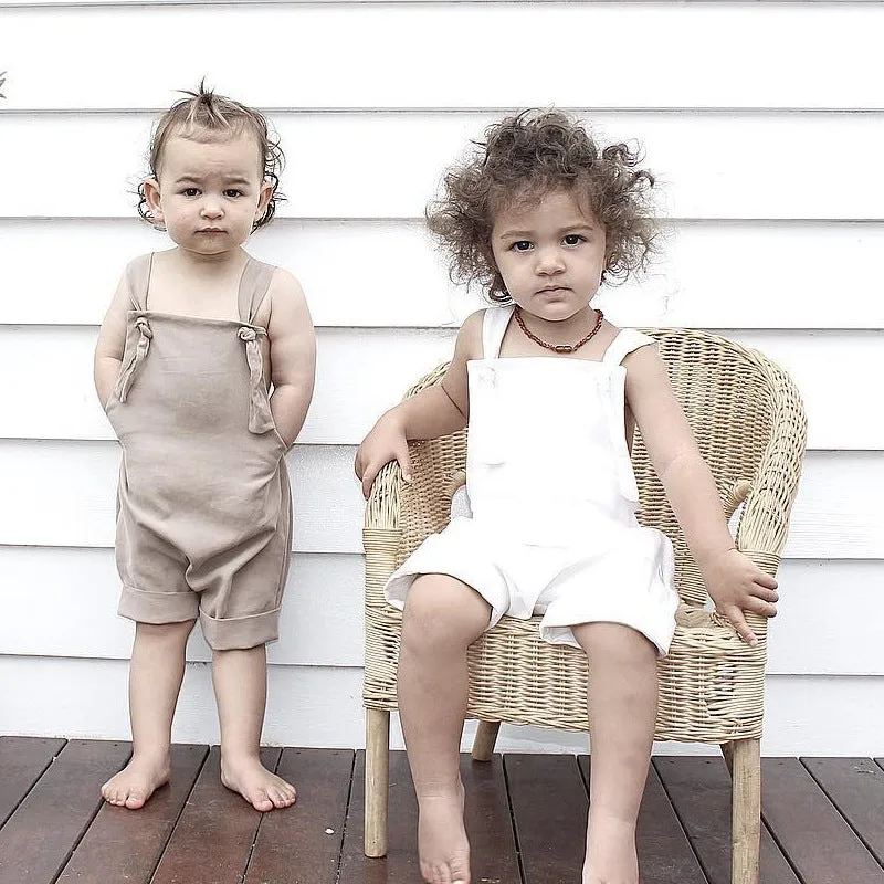 Children's khaki cotton overalls shorts with bow detail and straps, front view