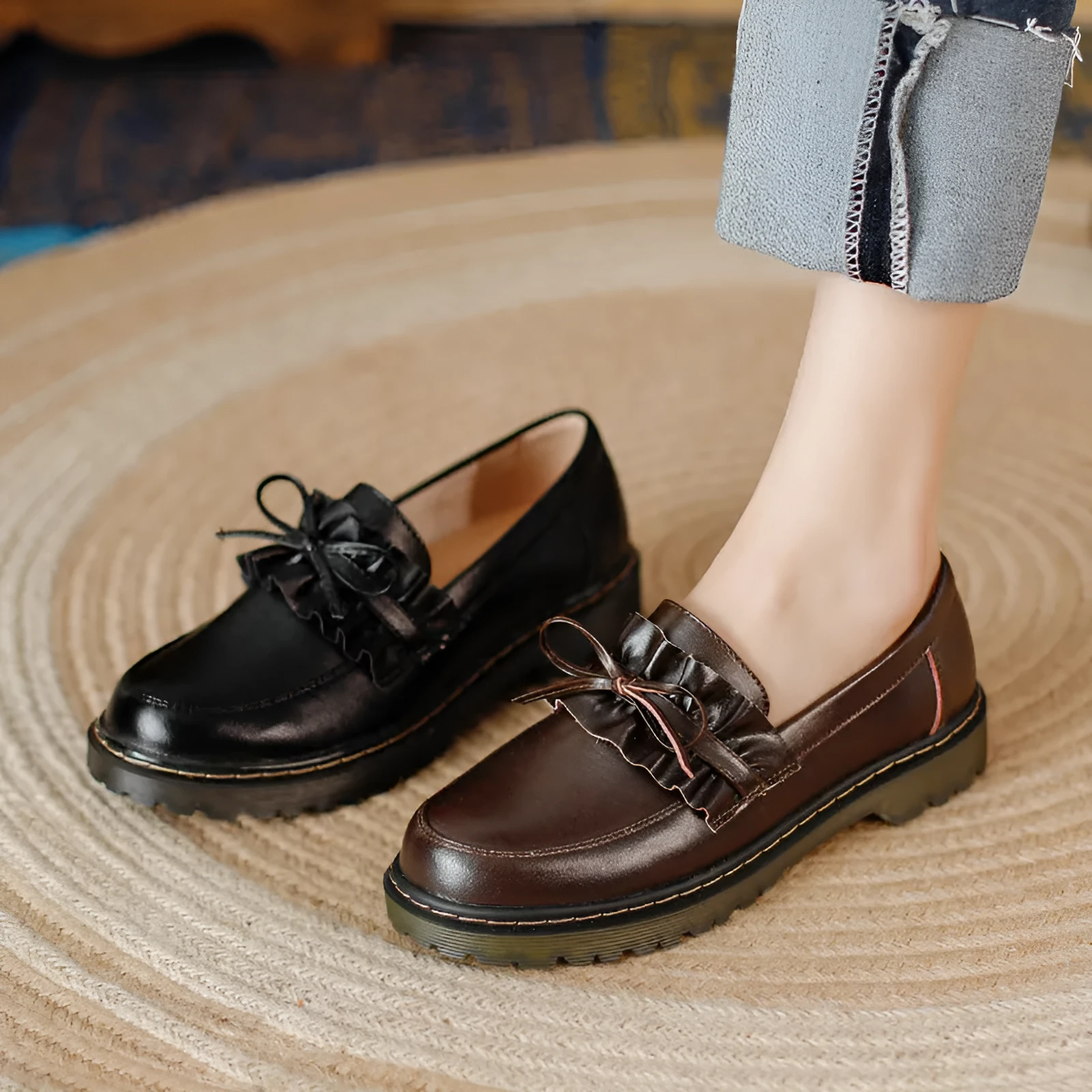 Women's black leather ankle boots with round toe and flat chunky heel, shown from the side.