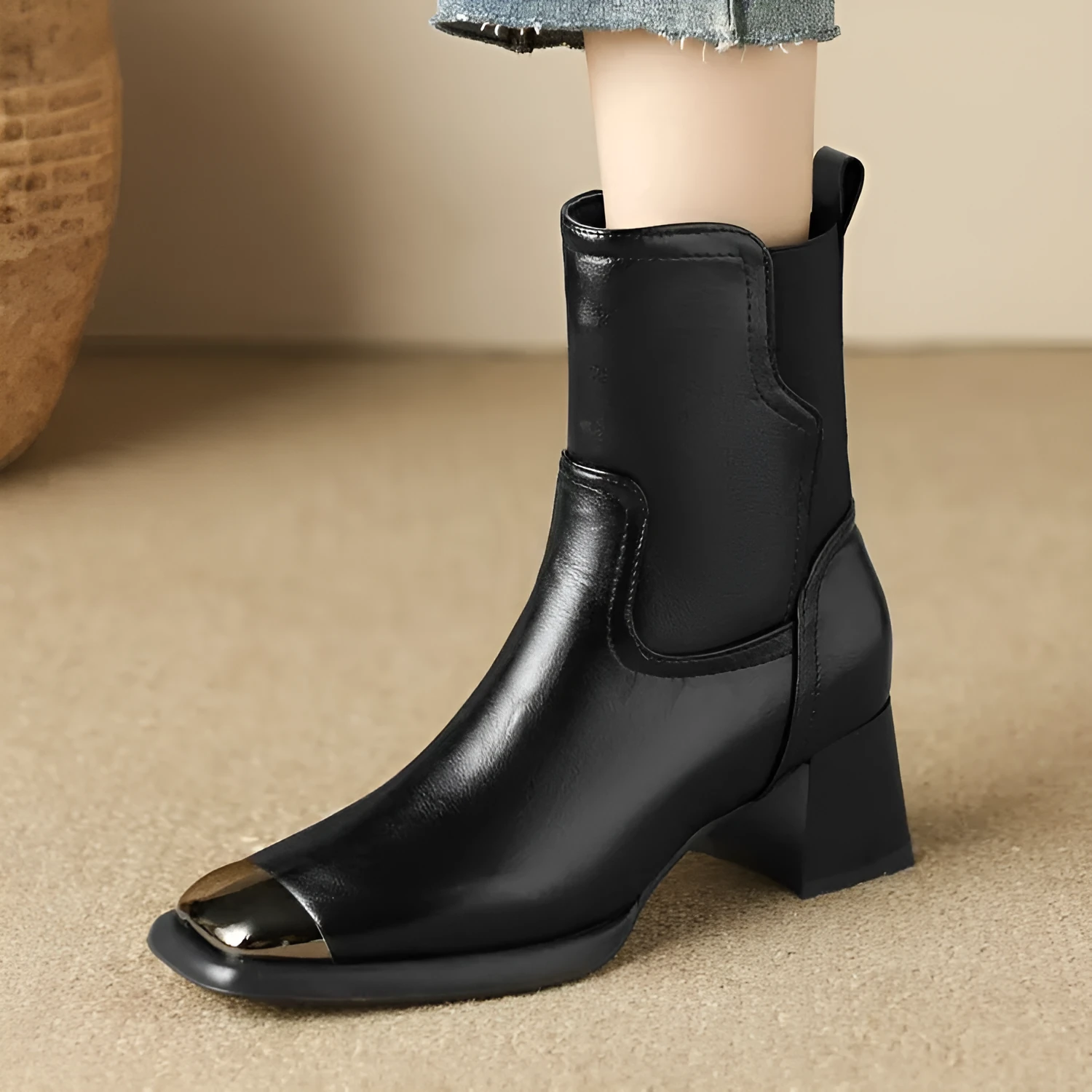 Brown high-heel Martin boots with side zipper and decorative metal rivet details.
