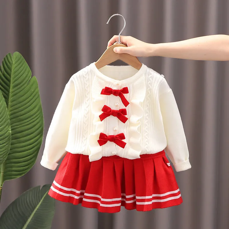Knitted baby girl two-piece skirt suit in pink with bow detail and long sleeves, autumn wear