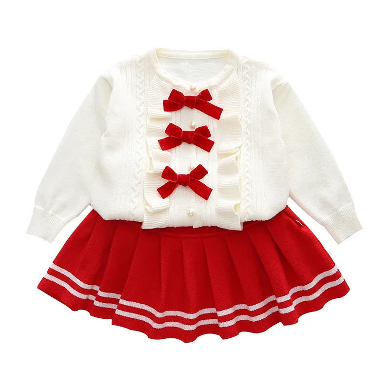Knitted baby girl two-piece skirt suit in pink with bow detail and long sleeves, autumn wear