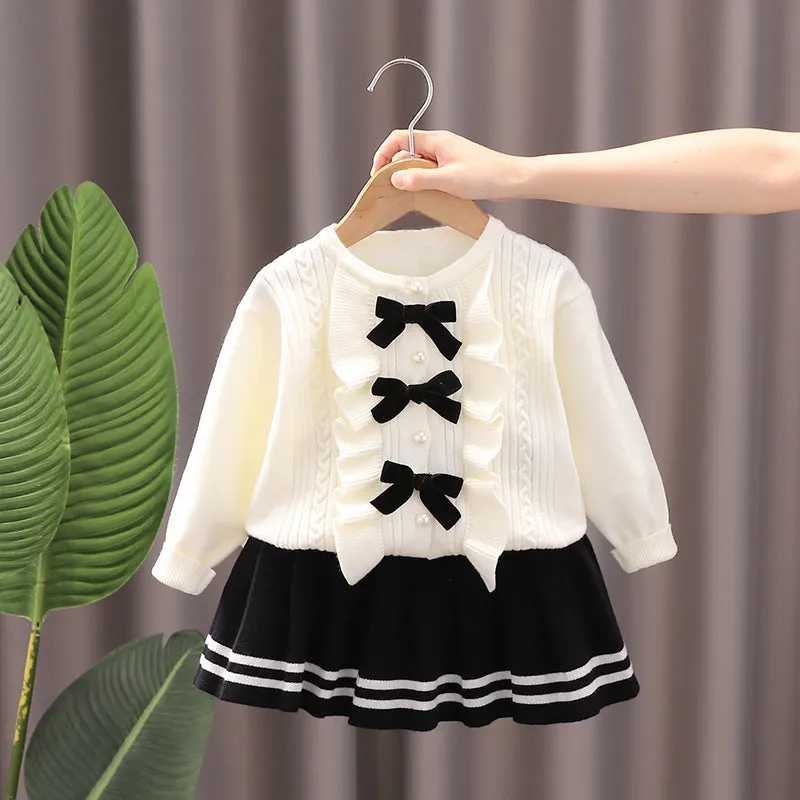 Knitted baby girl two-piece skirt suit in pink with bow detail and long sleeves, autumn wear