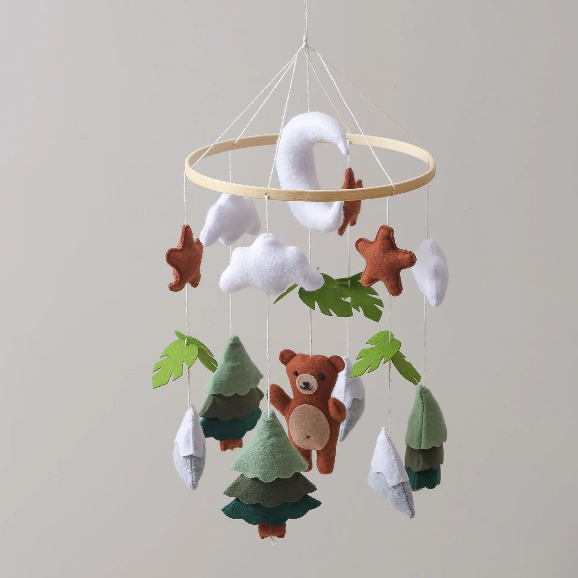 Handmade felt teddy bear bed bell in white on a wooden base for children's soothing sleep