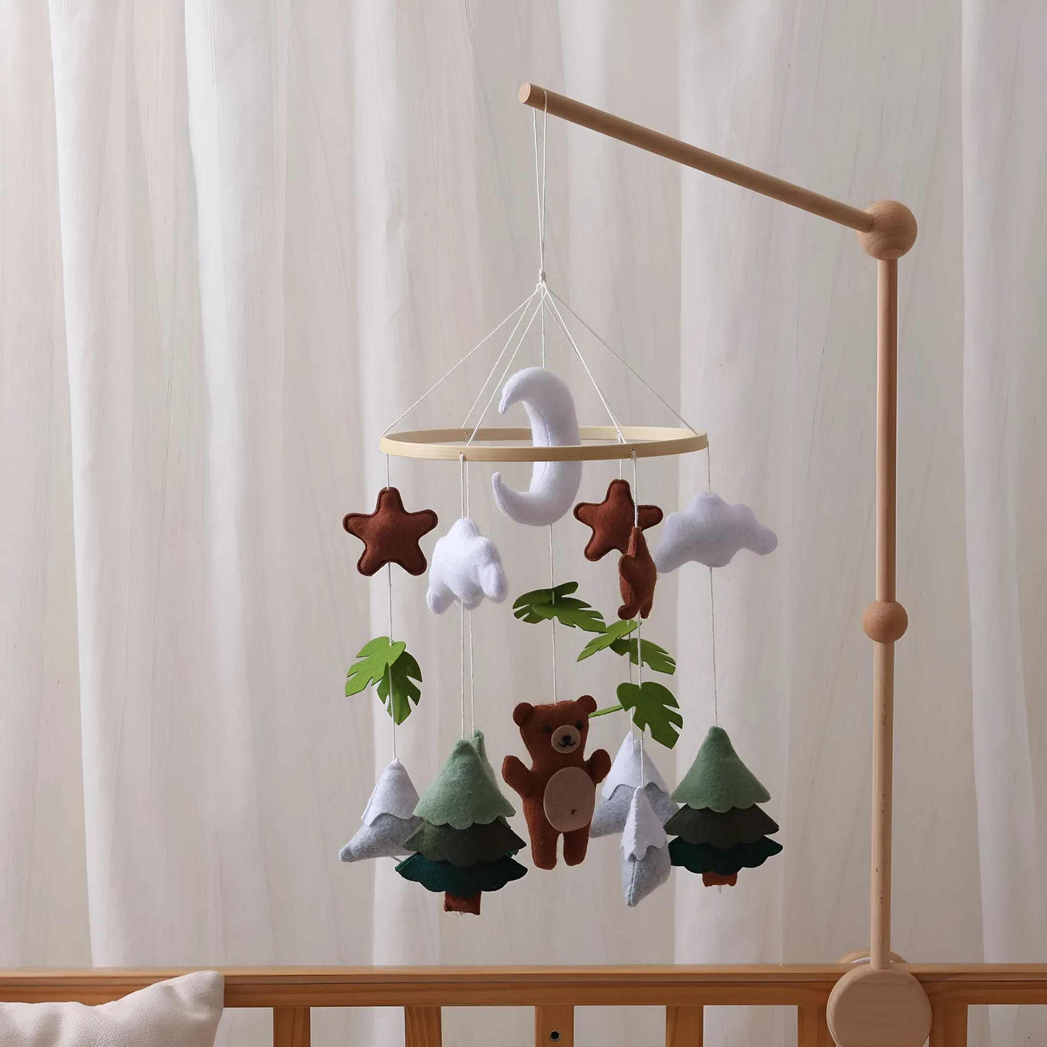 Handmade felt teddy bear bed bell in white on a wooden base for children's soothing sleep