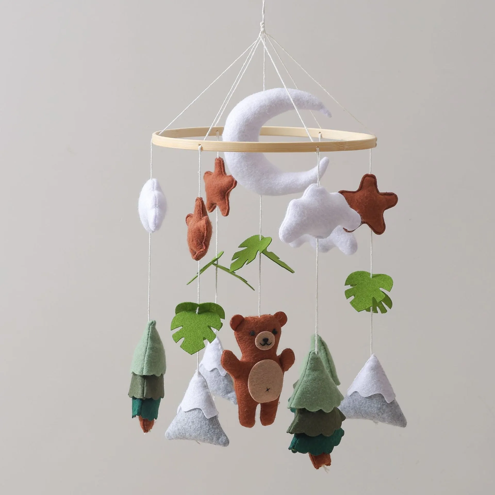 Handmade felt teddy bear bed bell in white on a wooden base for children's soothing sleep