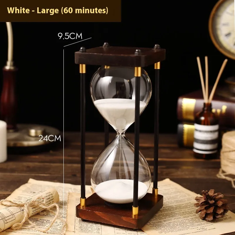 Wooden hourglass timer with solid wood frame and coloured sand on a desk