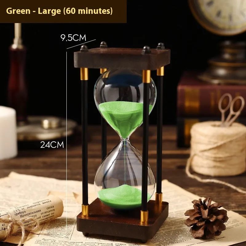 Wooden hourglass timer with solid wood frame and coloured sand on a desk