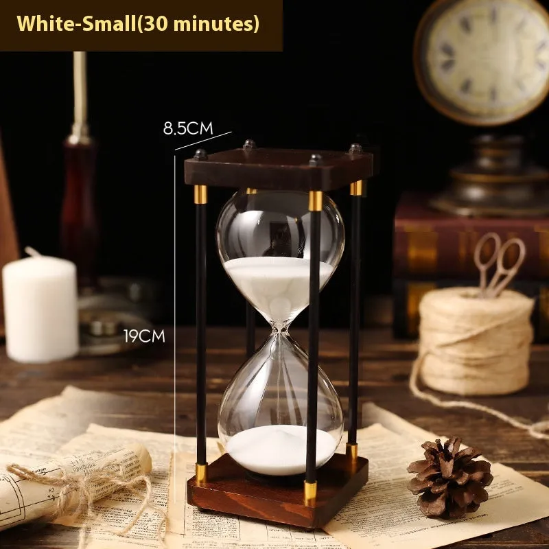 Wooden hourglass timer with solid wood frame and coloured sand on a desk