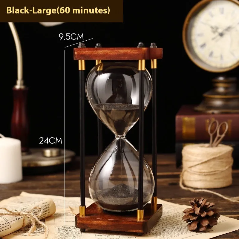 Wooden hourglass timer with solid wood frame and coloured sand on a desk