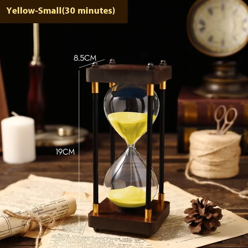 Wooden hourglass timer with solid wood frame and coloured sand on a desk