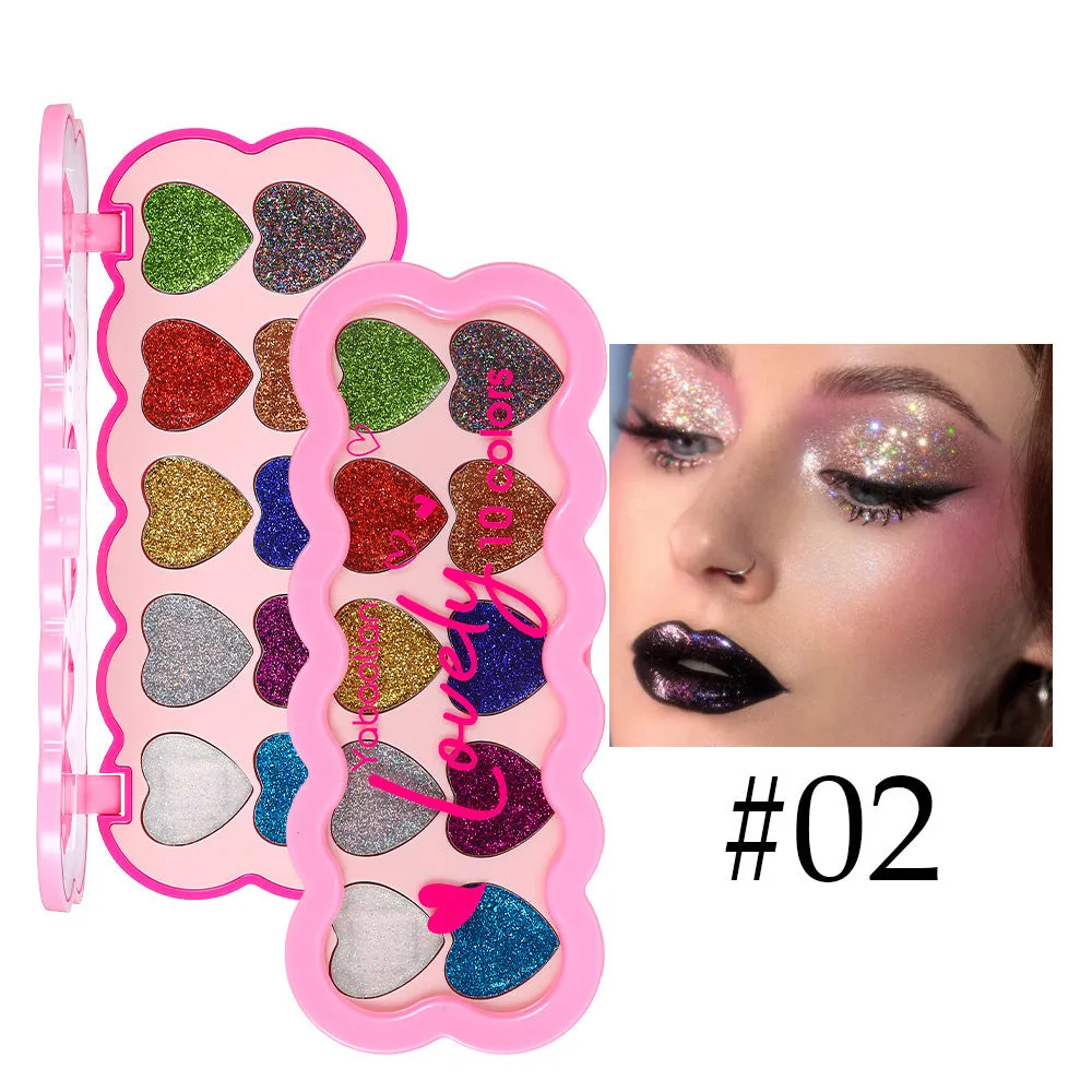 Heart-shaped compact open to show ten pans of pearlescent sequin eyeshadow in various colours.