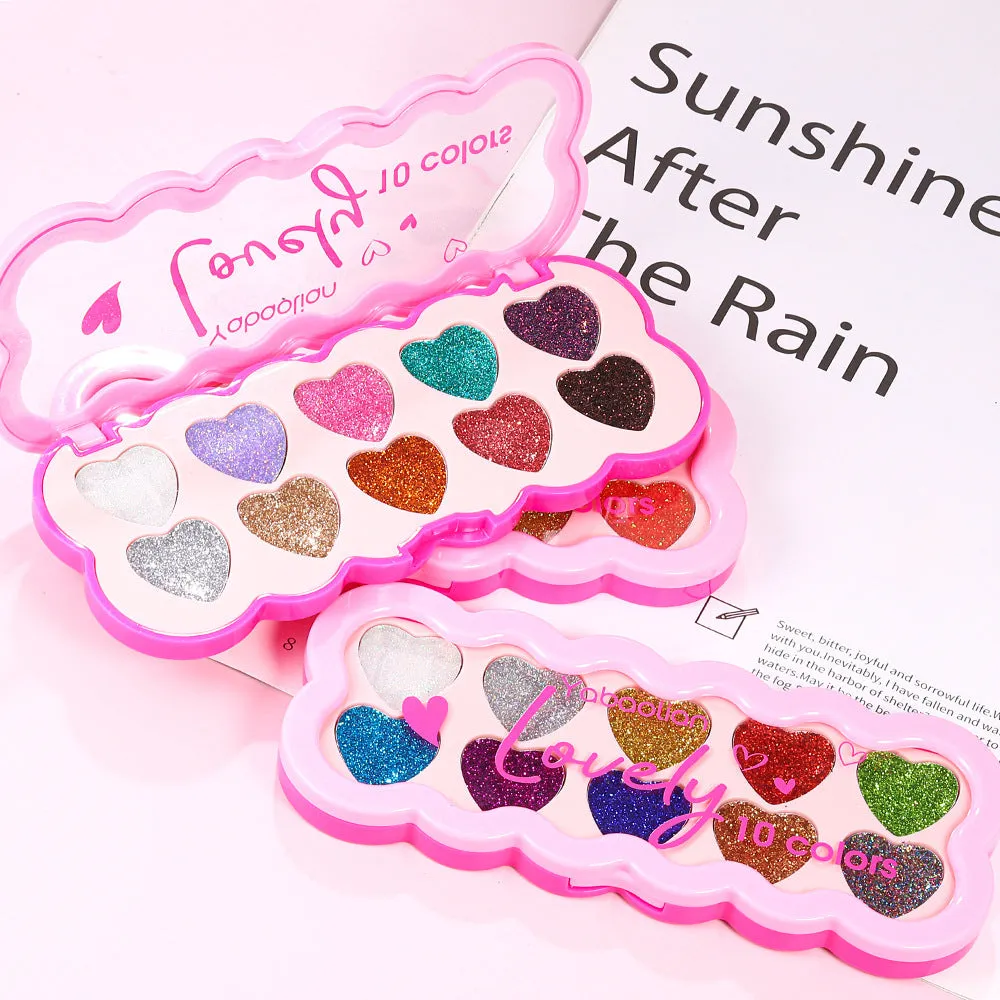 Heart-shaped compact open to show ten pans of pearlescent sequin eyeshadow in various colours.
