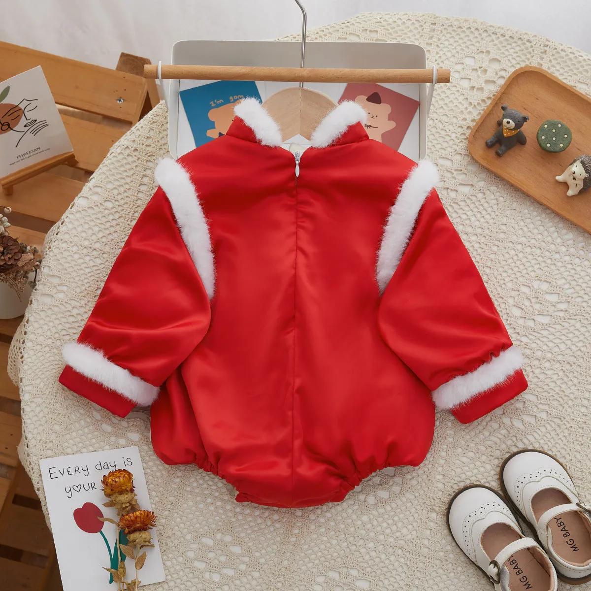 Red thickened baby triangle jumpsuit with long sleeves and pullover style on white background