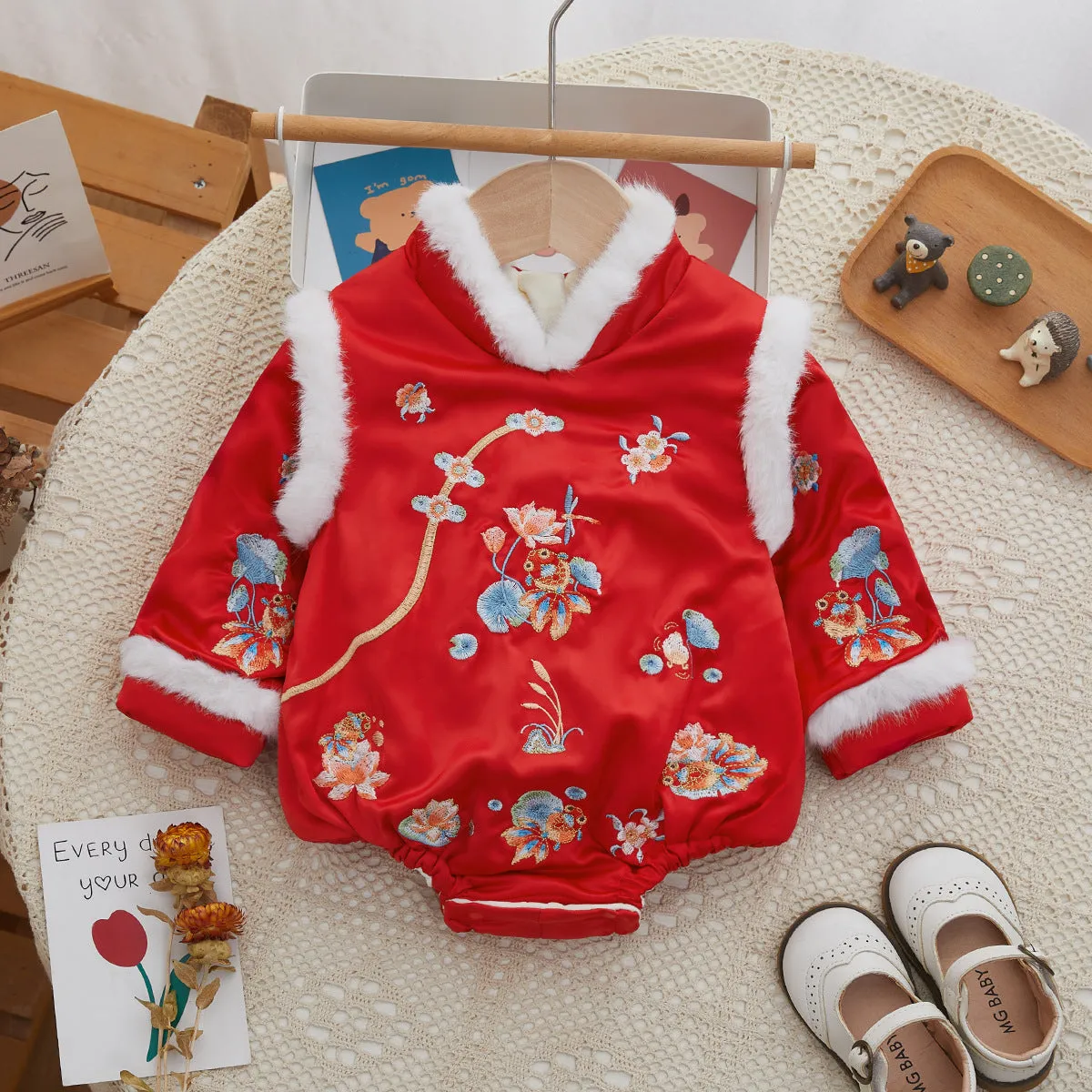 Red thickened baby triangle jumpsuit with long sleeves and pullover style on white background