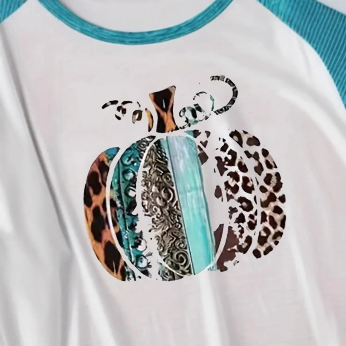 Sky blue long sleeve t-shirt with a white 3D digitally printed Halloween pumpkin graphic.