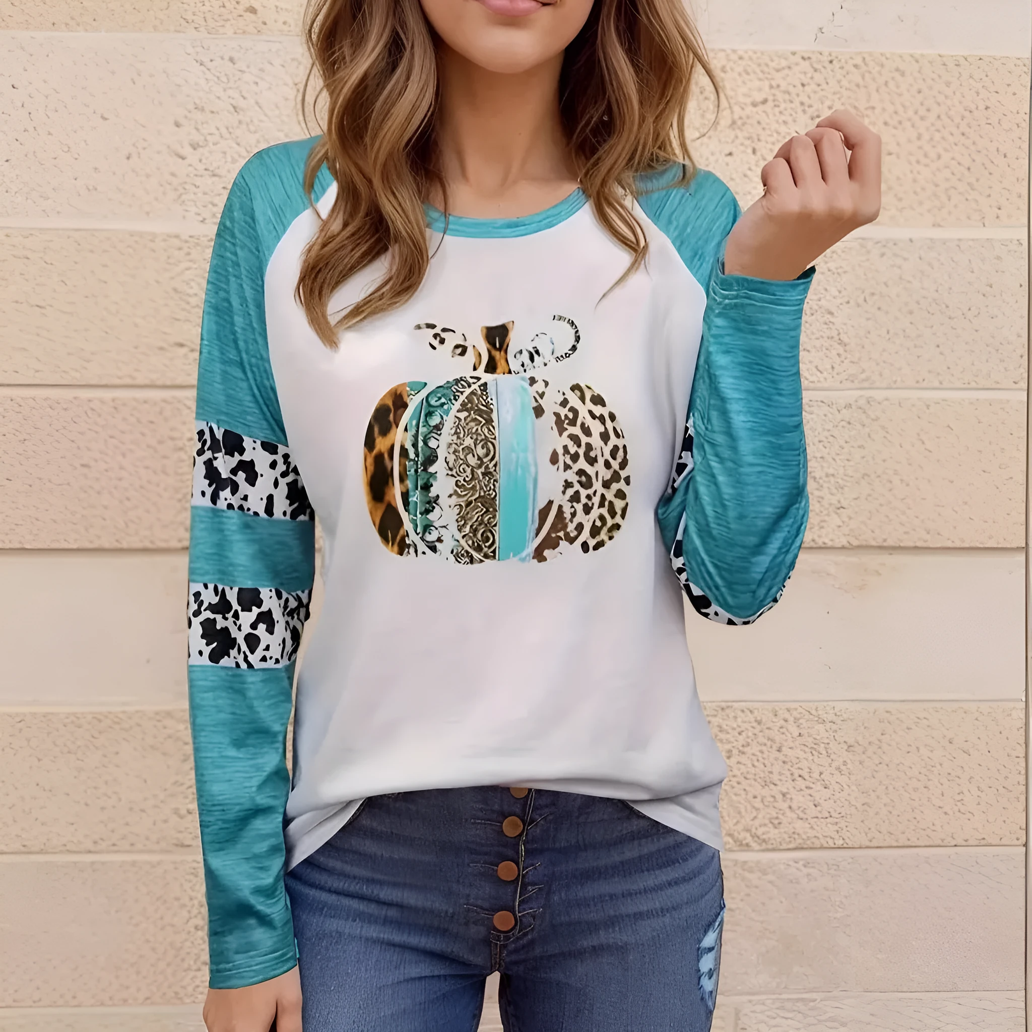 Sky blue long sleeve t-shirt with a white 3D digitally printed Halloween pumpkin graphic.
