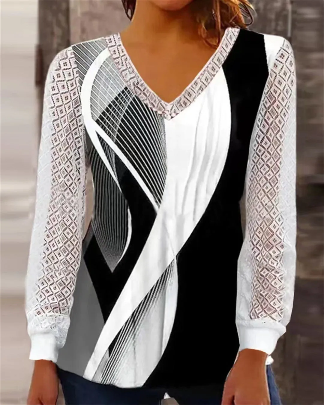 Purple women's loose V-neck top with hollow-out lace detailing on a hanger.