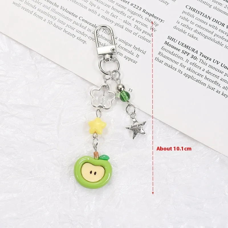 Fruit-themed mobile phone charm keychain with apple and strawberry designs in plastic/resin construction