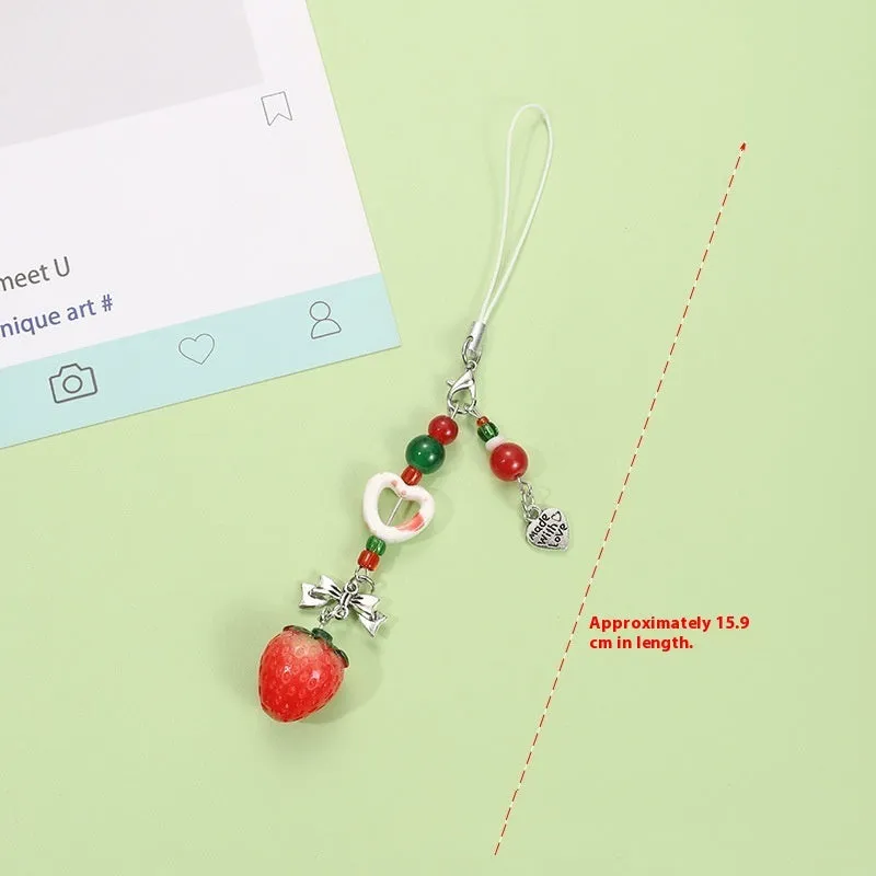 Fruit-themed mobile phone charm keychain with apple and strawberry designs in plastic/resin construction