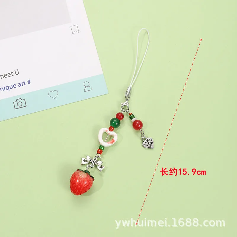 Fruit-themed mobile phone charm keychain with apple and strawberry designs in plastic/resin construction