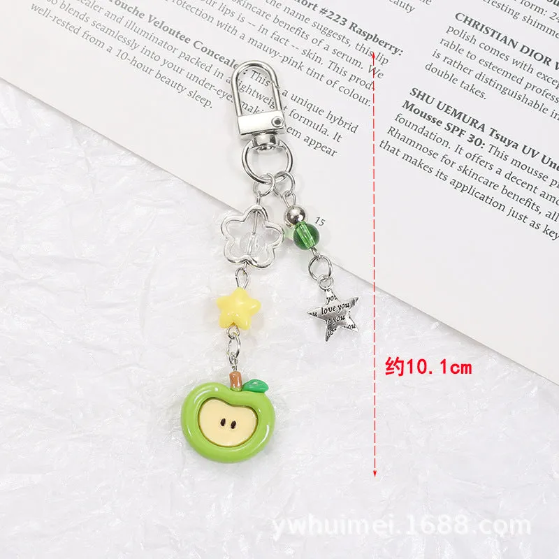 Fruit-themed mobile phone charm keychain with apple and strawberry designs in plastic/resin construction