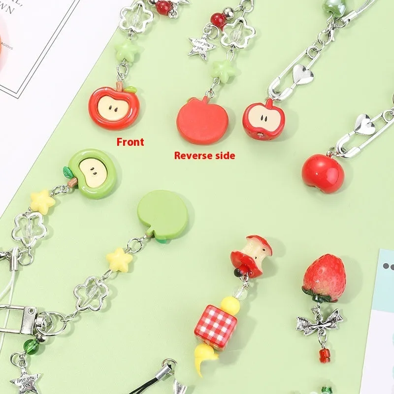 Fruit-themed mobile phone charm keychain with apple and strawberry designs in plastic/resin construction