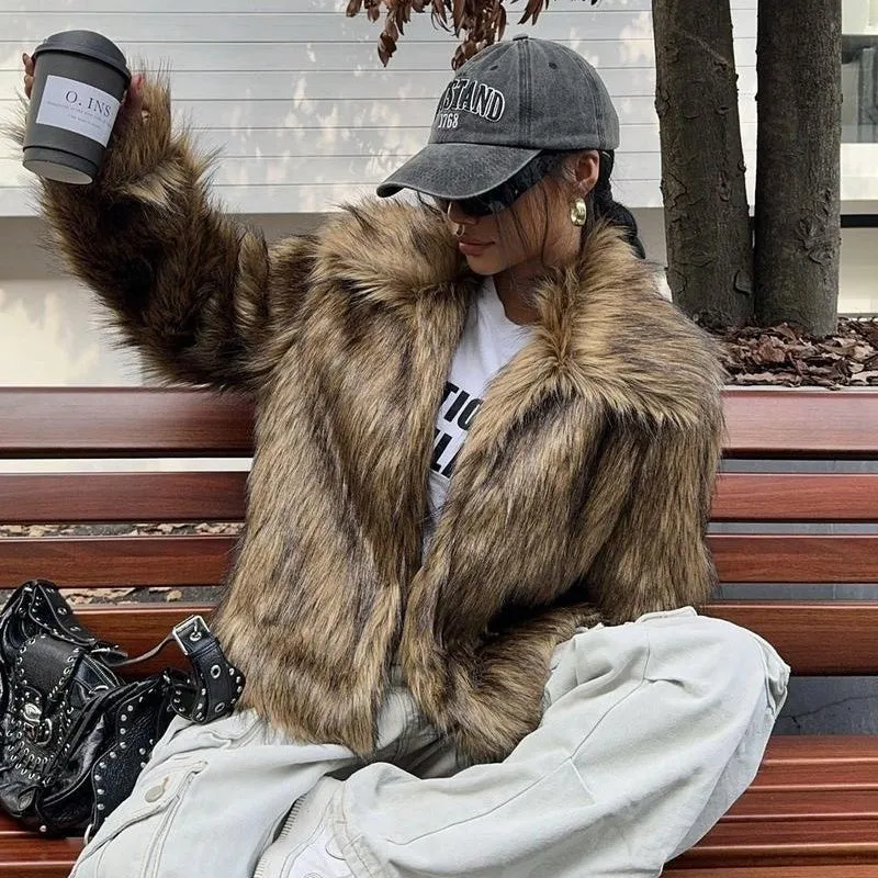 Women's short black tip artificial fur winter coat with a large fur collar and long sleeves.
