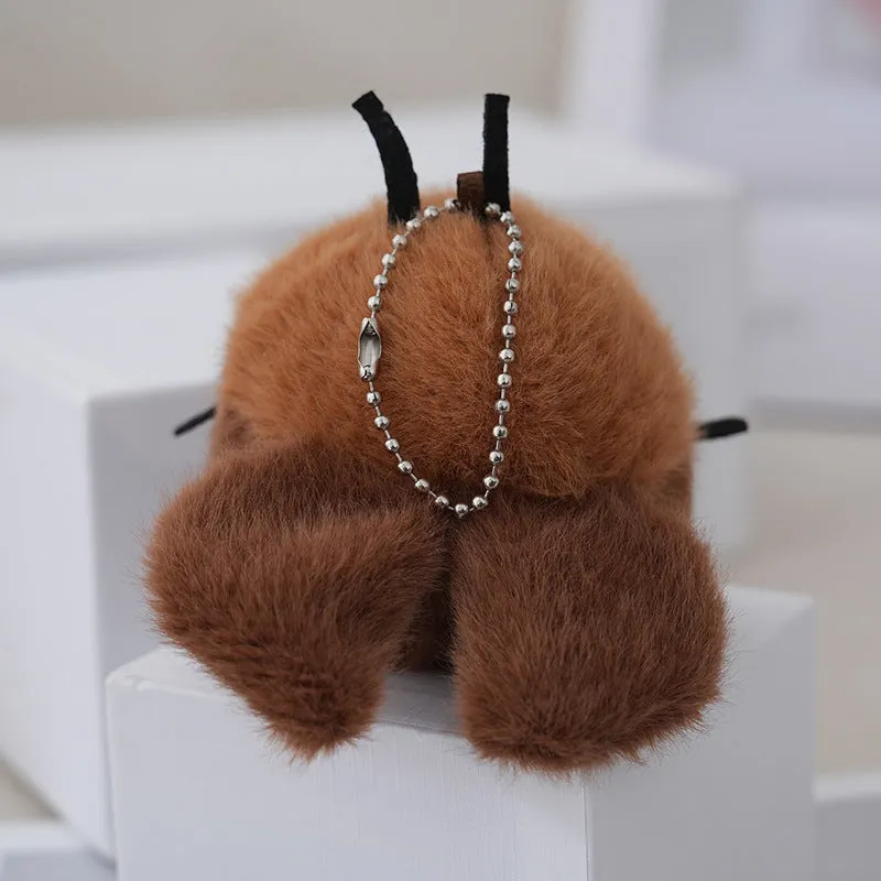 Small mink velvet cockroach pendant plush toy doll with black eyes, 8cm height, on a light background