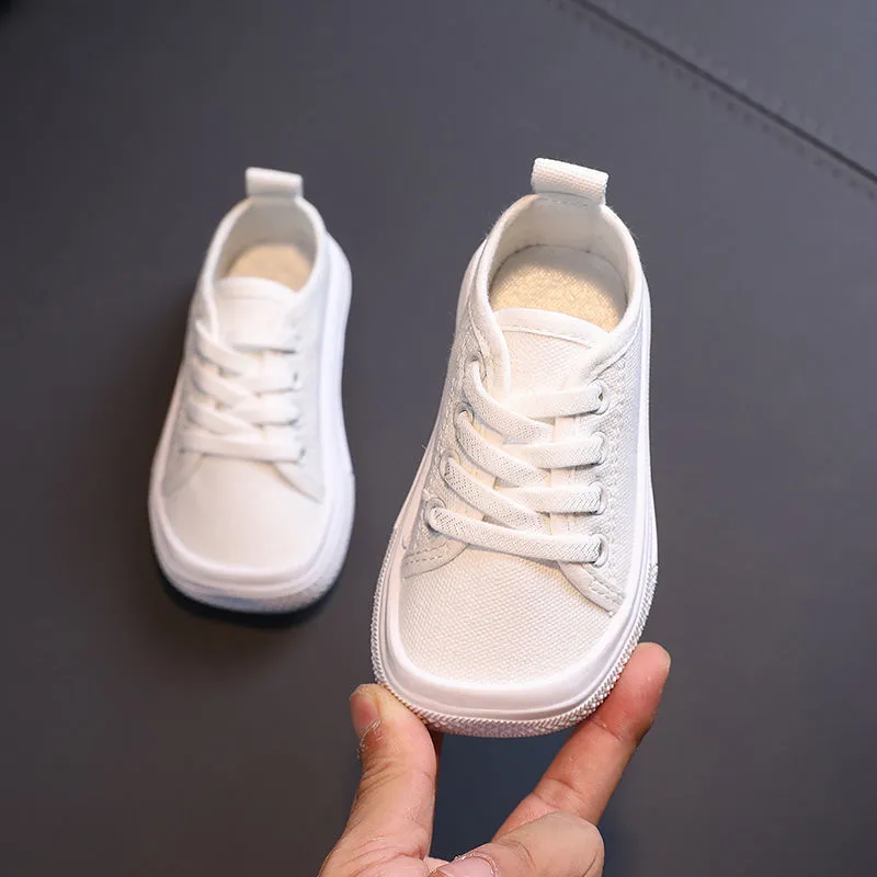 Children's canvas shoes low top sneakers in orange black white leopard print and plaid on a white background