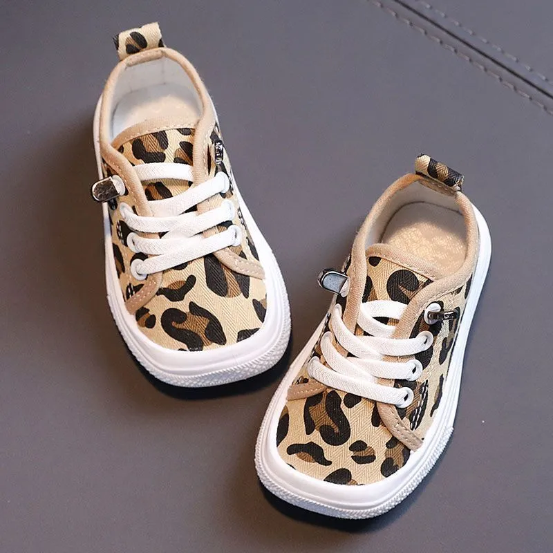 Children's canvas shoes low top sneakers in orange black white leopard print and plaid on a white background
