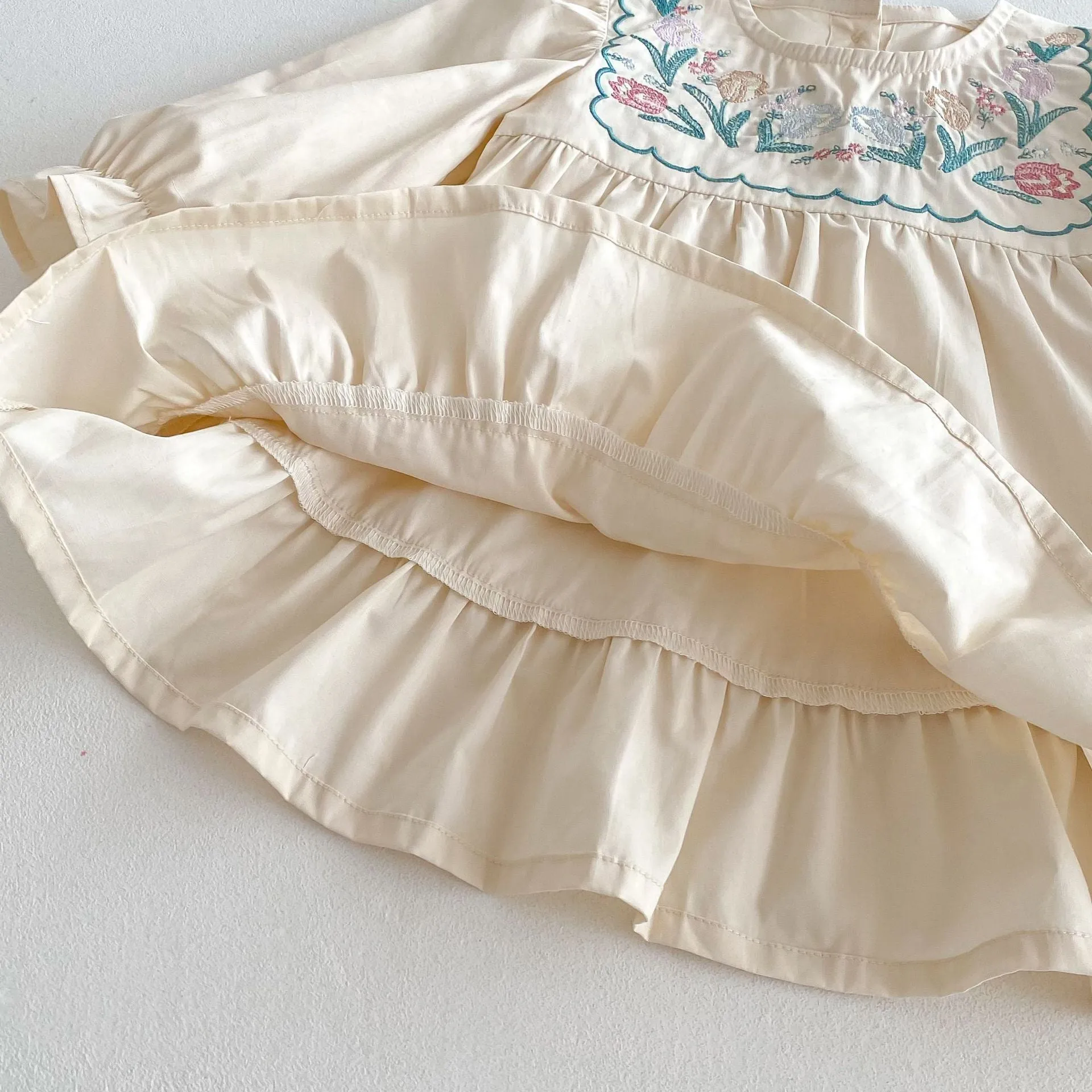 Girls' ruffled long sleeve flower embroidered princess dress in apricot colour on a child model
