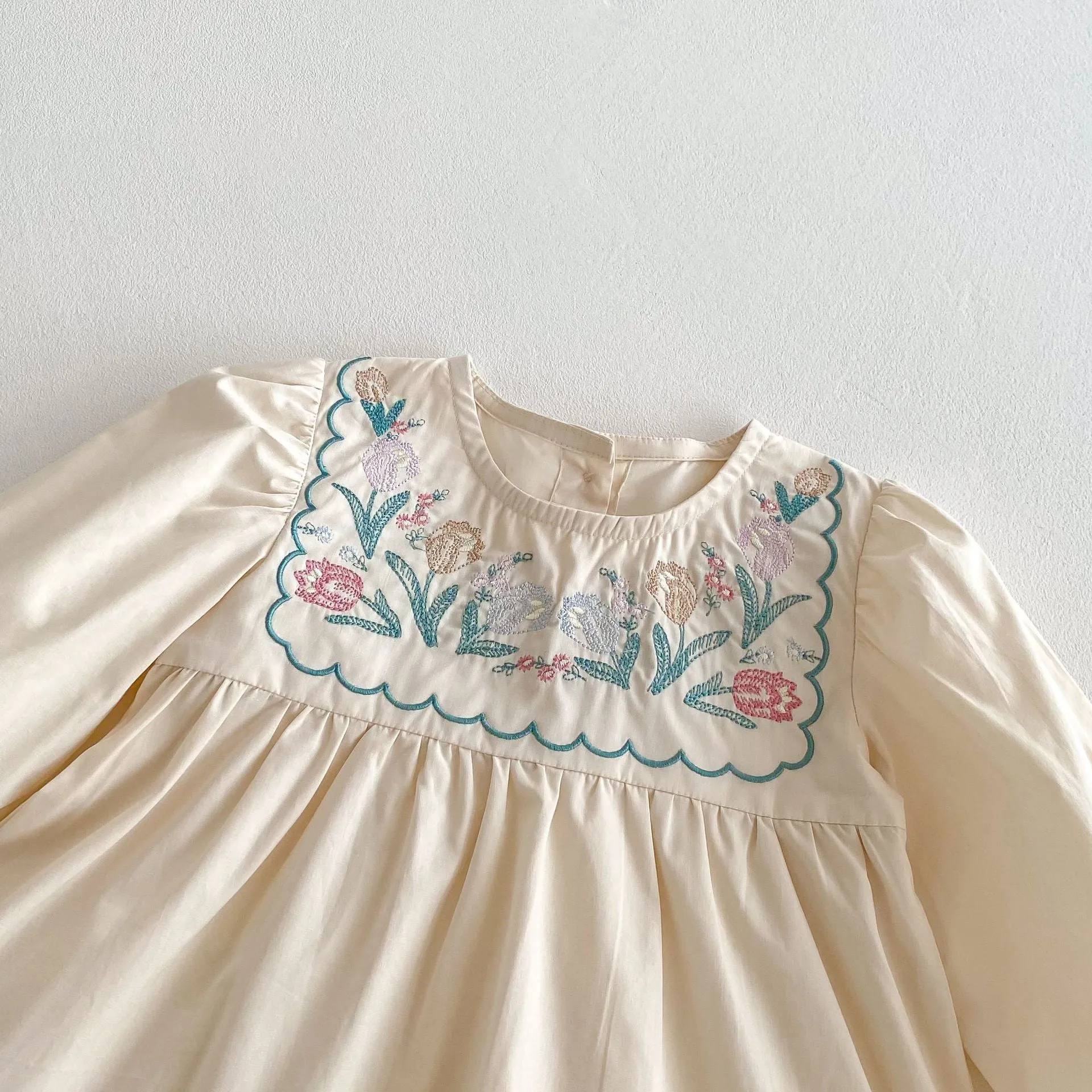 Girls' ruffled long sleeve flower embroidered princess dress in apricot colour on a child model