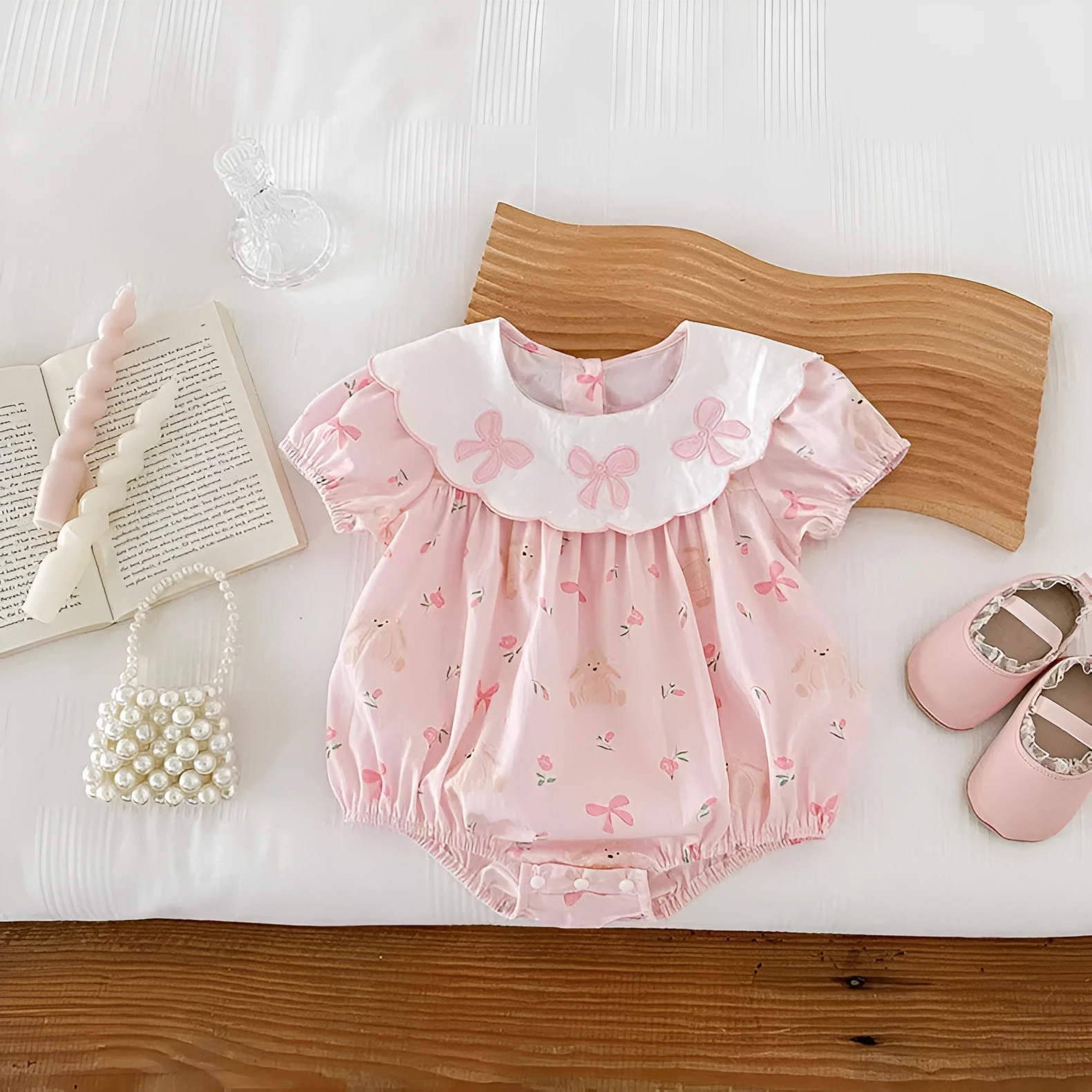 Pink cotton triangle romper jumpsuit for baby girl with three bow details, short sleeves, suitable for height 66-90cm