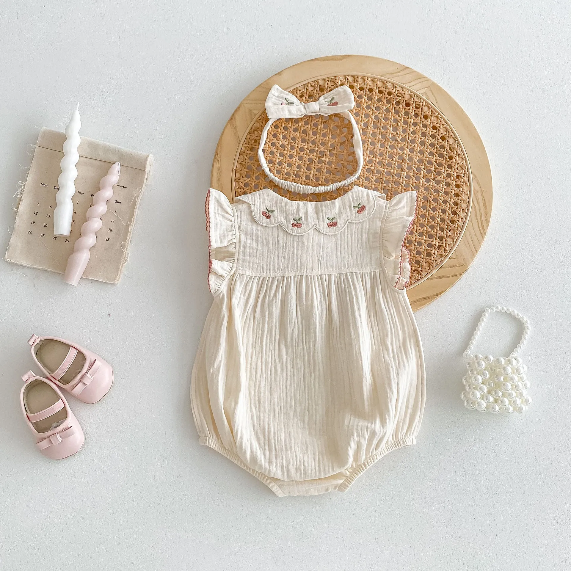 Summer cotton baby jumpsuit in apricot with double-breasted closure and matching hair band